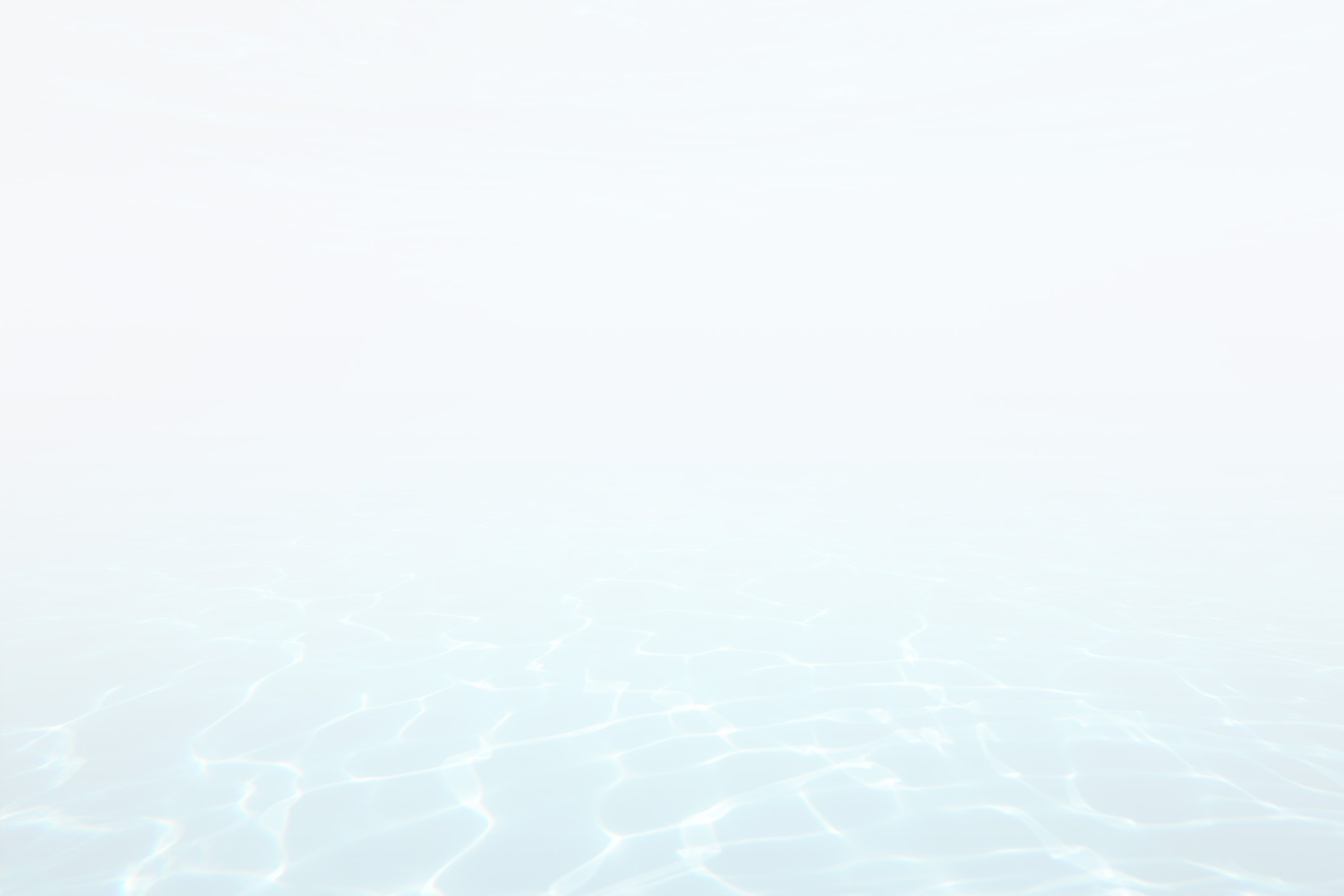 This image features a tranquil scene with a soft gradient of white to light blue, showcasing the gentle ripples of clear, shallow water under diffuse light.